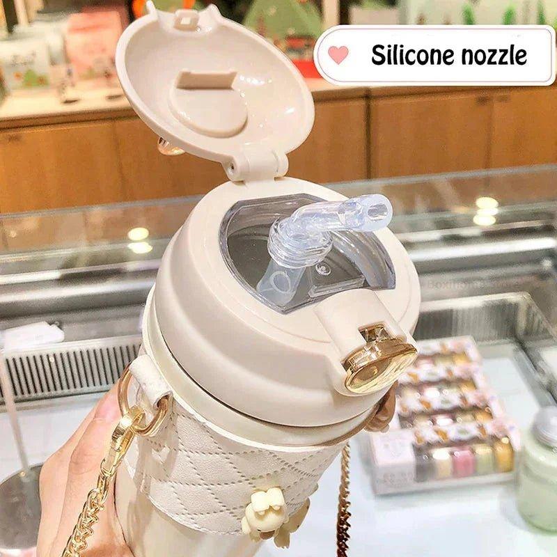 Stylish beige water bottle with silicone nozzle, gold chain strap, and quilted design for women's fashion