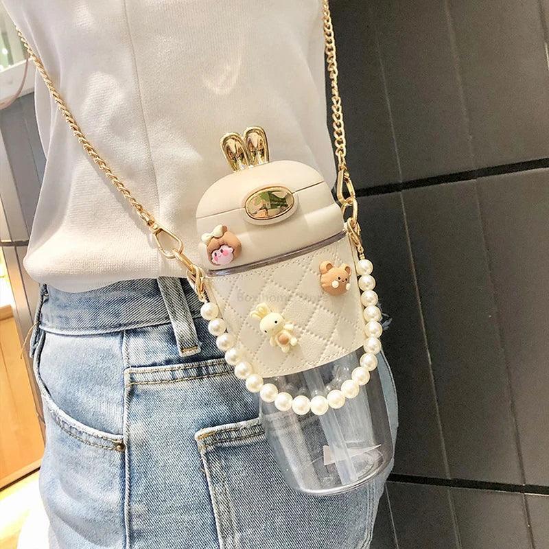 Cute pearl-embellished crossbody water bottle bag with bunny ears, perfect for women's fashion
