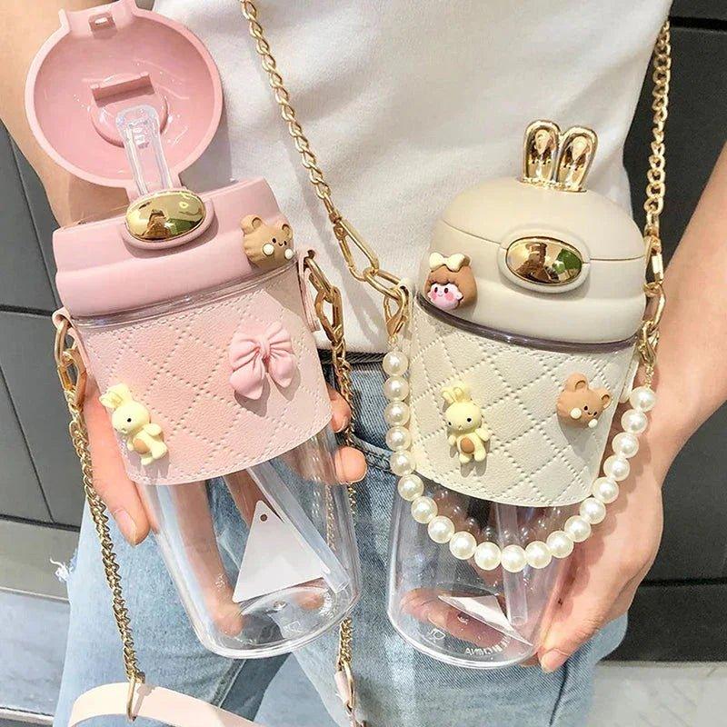 Cute pastel water bottles with pearl straps, bunny ears, and bow charms for women's fashion