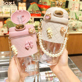 Cute pink and white quilted water bottles with pearl straps, bunny charms, and bow details for women's fashion