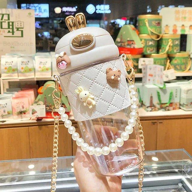 Cute white quilted water bottle with pearl strap, bunny charm, and gold accents for women's fashion