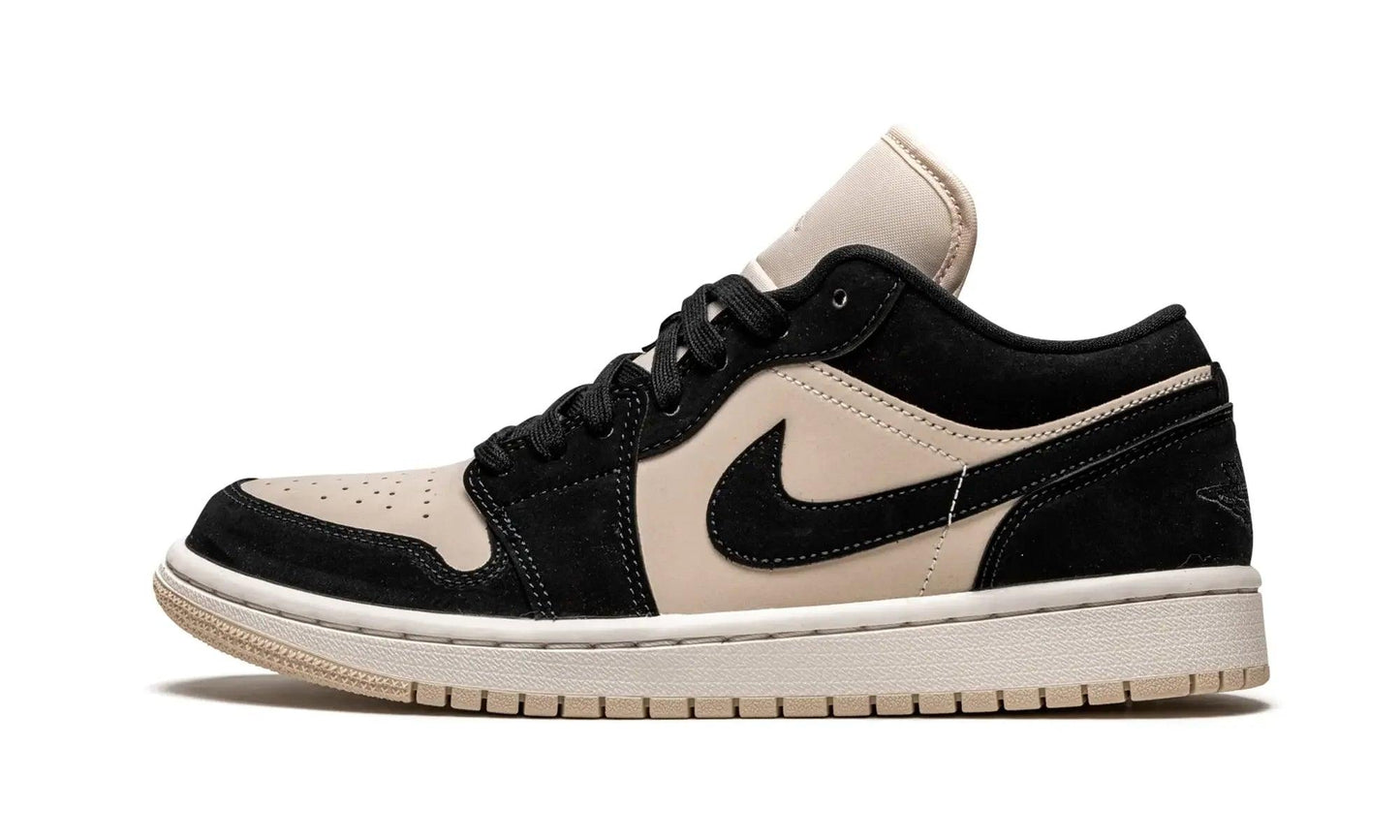 Black and beige low-top sneaker with suede texture and iconic swoosh design