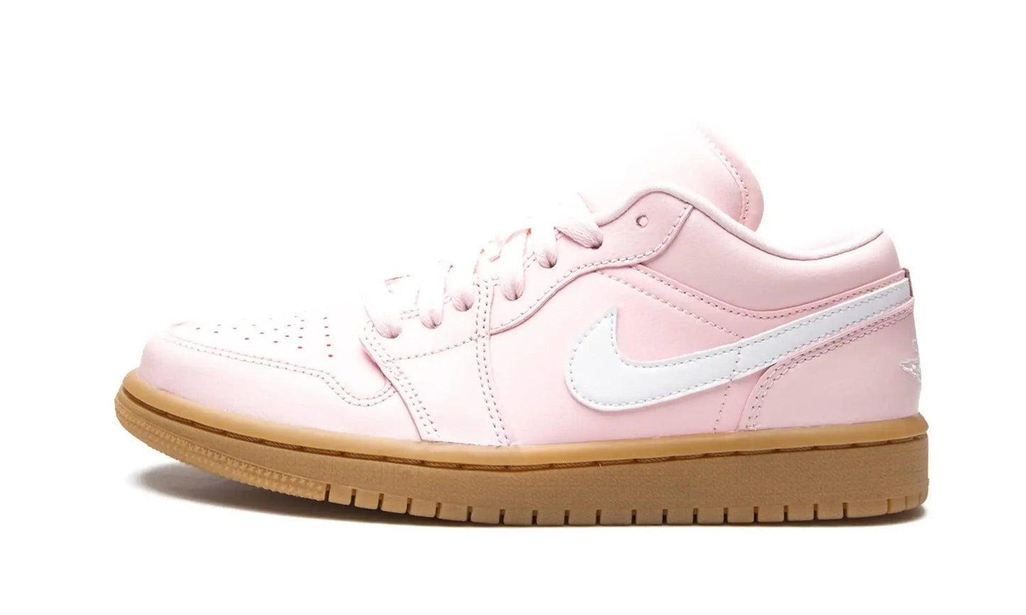 Pink women's low-top sneaker with white swoosh and gum sole, stylish fashion footwear