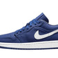 Navy blue low-top sneaker with white swoosh and sole, stylish women's fashion footwear