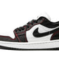 Black and white low-top sneaker with red stitching, Nike swoosh, and canvas texture for women's fashion
