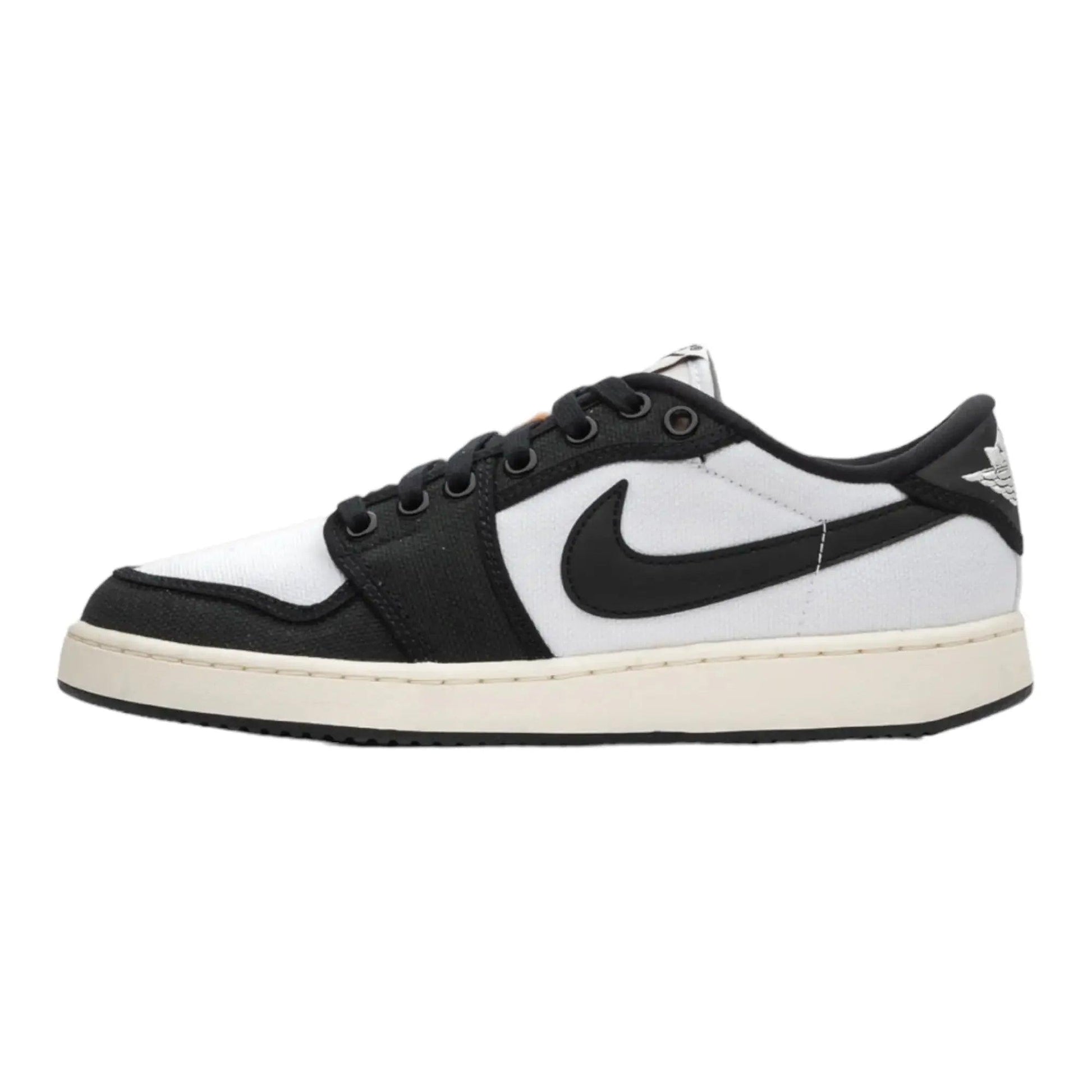 Black and white Nike Air Jordan 1 low-top sneaker with classic swoosh logo and cream sole
