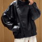 Woman wearing black leather moto jacket with puff sleeves, styled with white lace shorts for trendy fashion look