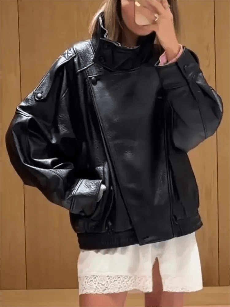 Woman wearing black leather moto jacket with puff sleeves, styled with white lace shorts for trendy fashion look