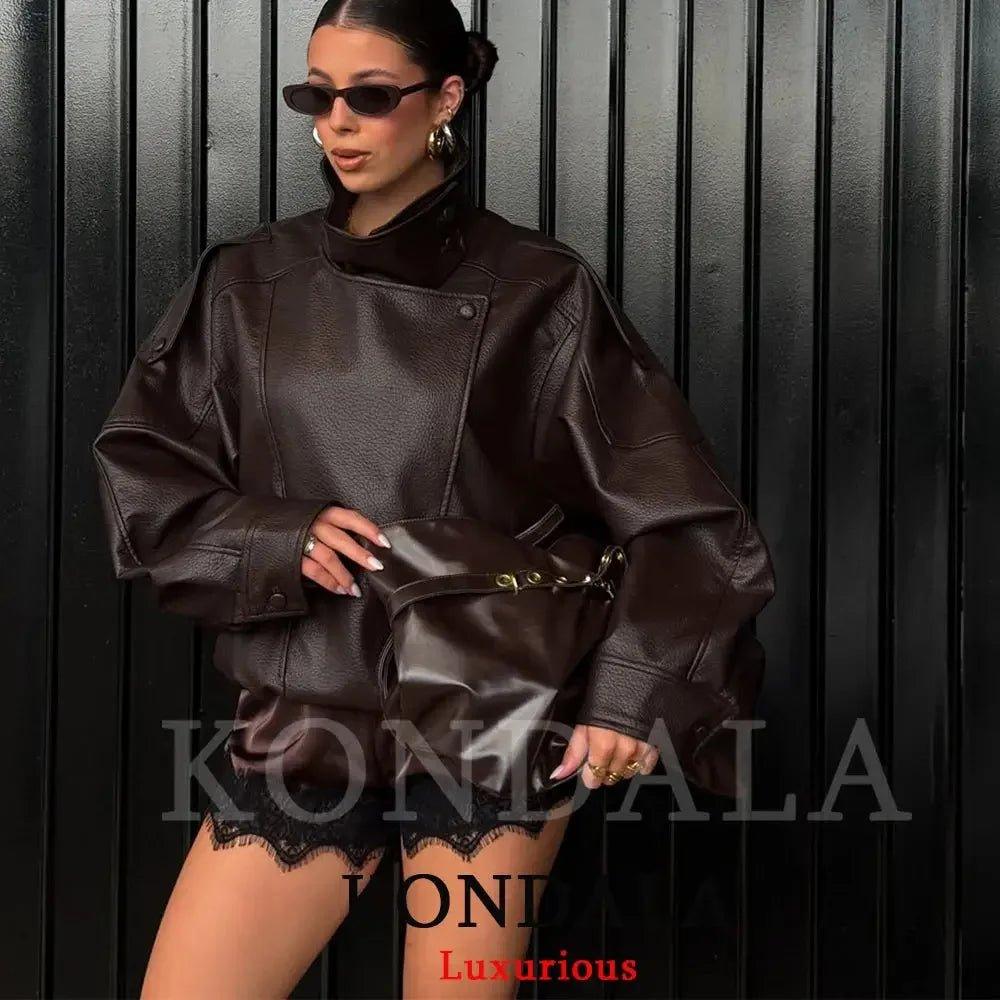 Woman in stylish brown leather jacket and lace shorts, fashion-forward look