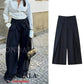 Black wide-leg pleated trousers with striped blouse, stylish women's fashion outfit