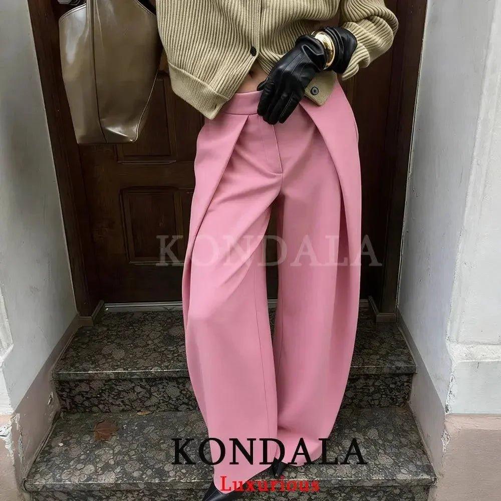 Pink wide-leg trousers with pleated front, styled with beige cardigan and black gloves for women’s fashion