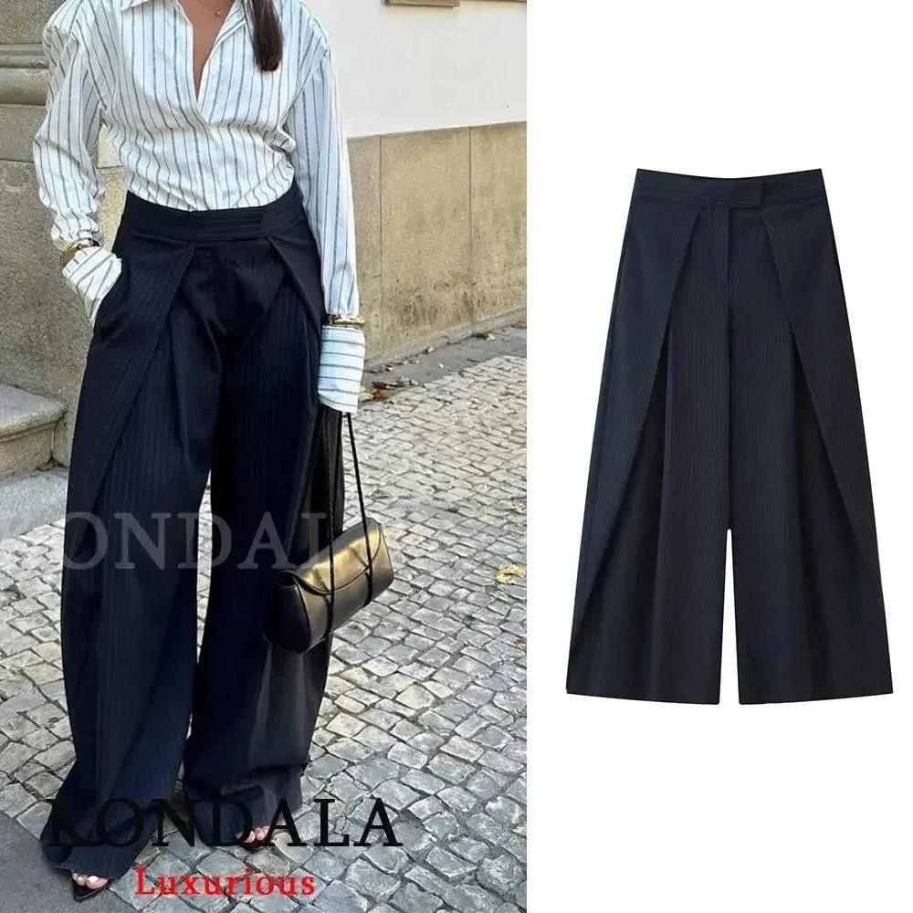 Women's black pleated wide-leg pants with striped blouse, stylish streetwear fashion