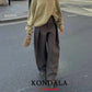 Woman in beige sweater and wide-leg brown pants, street style fashion