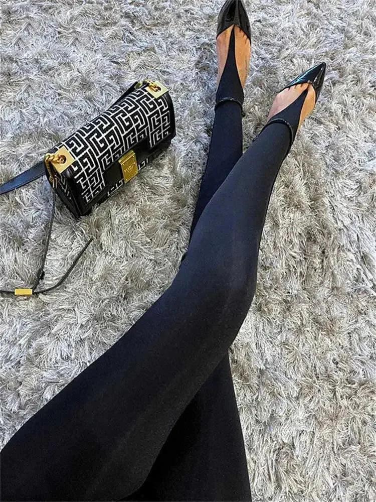 Black tights with pointed-toe flats and patterned handbag on fluffy rug, women's fashion