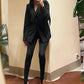 Woman in black blazer suit with high heels, taking mirror selfie for fashion look