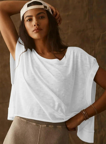 Woman in white oversized t-shirt and cap, casual fashion style