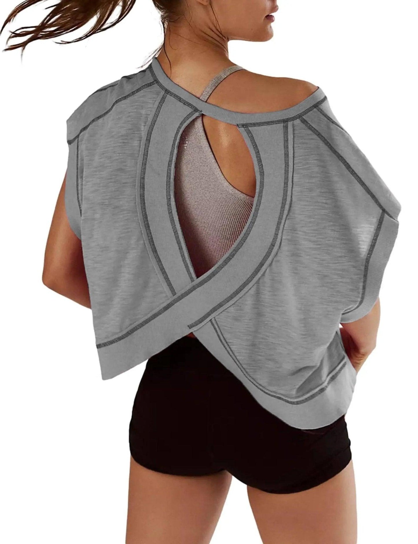 Gray women's open-back workout top with crisscross straps and black shorts, ideal for gym or yoga fashion