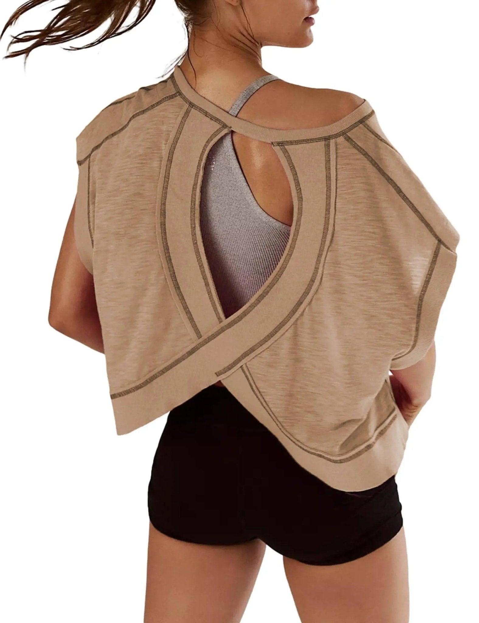 Beige open-back workout top with cutout design, paired with black shorts for women's fashion