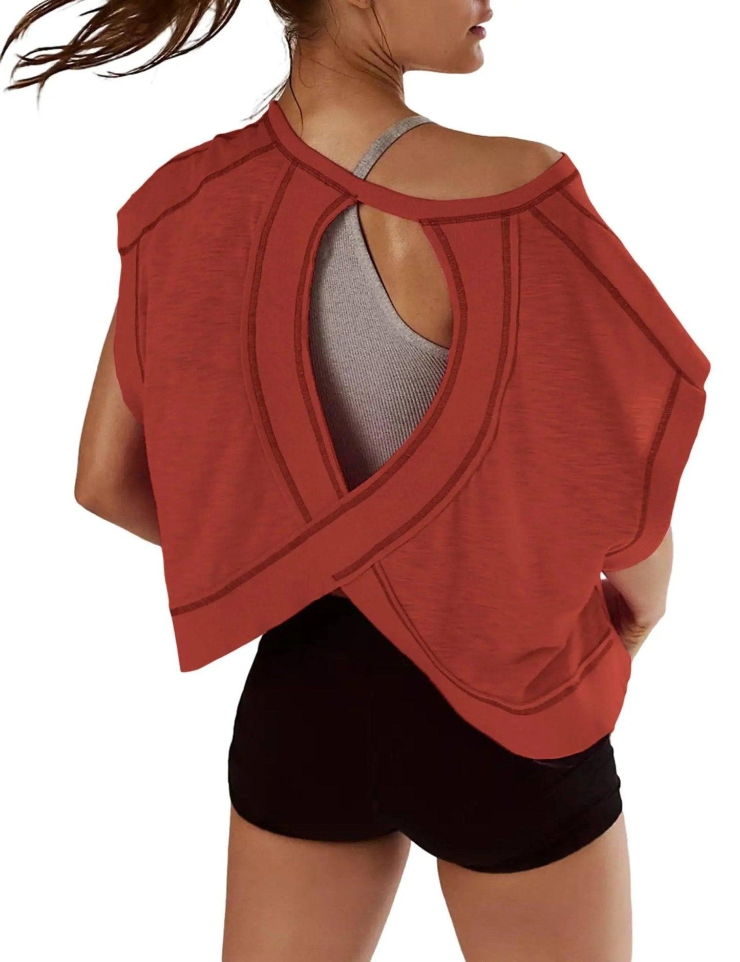 Rust red open-back women's workout top with gray sports bra and black shorts, fashion fitness wear