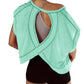 Mint green open-back workout top with crisscross design, paired with black shorts for women's active fashion