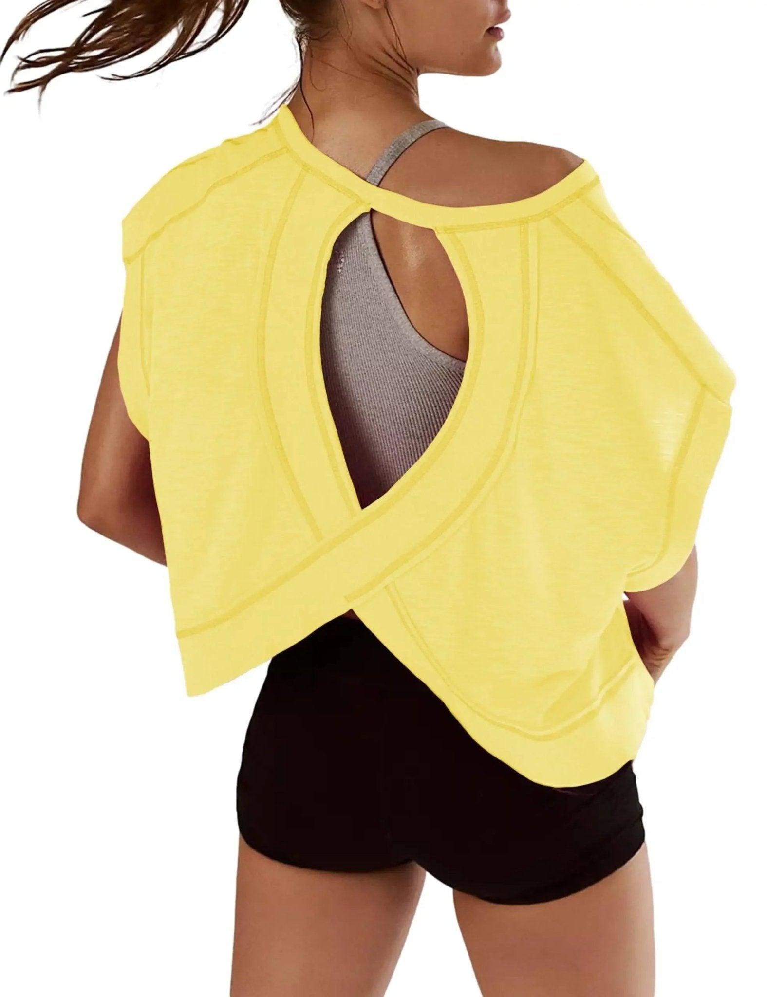 Yellow open-back workout top with gray sports bra and black shorts for women's fitness fashion
