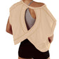 Beige open-back workout top with crisscross design, paired with black shorts for women's fitness fashion