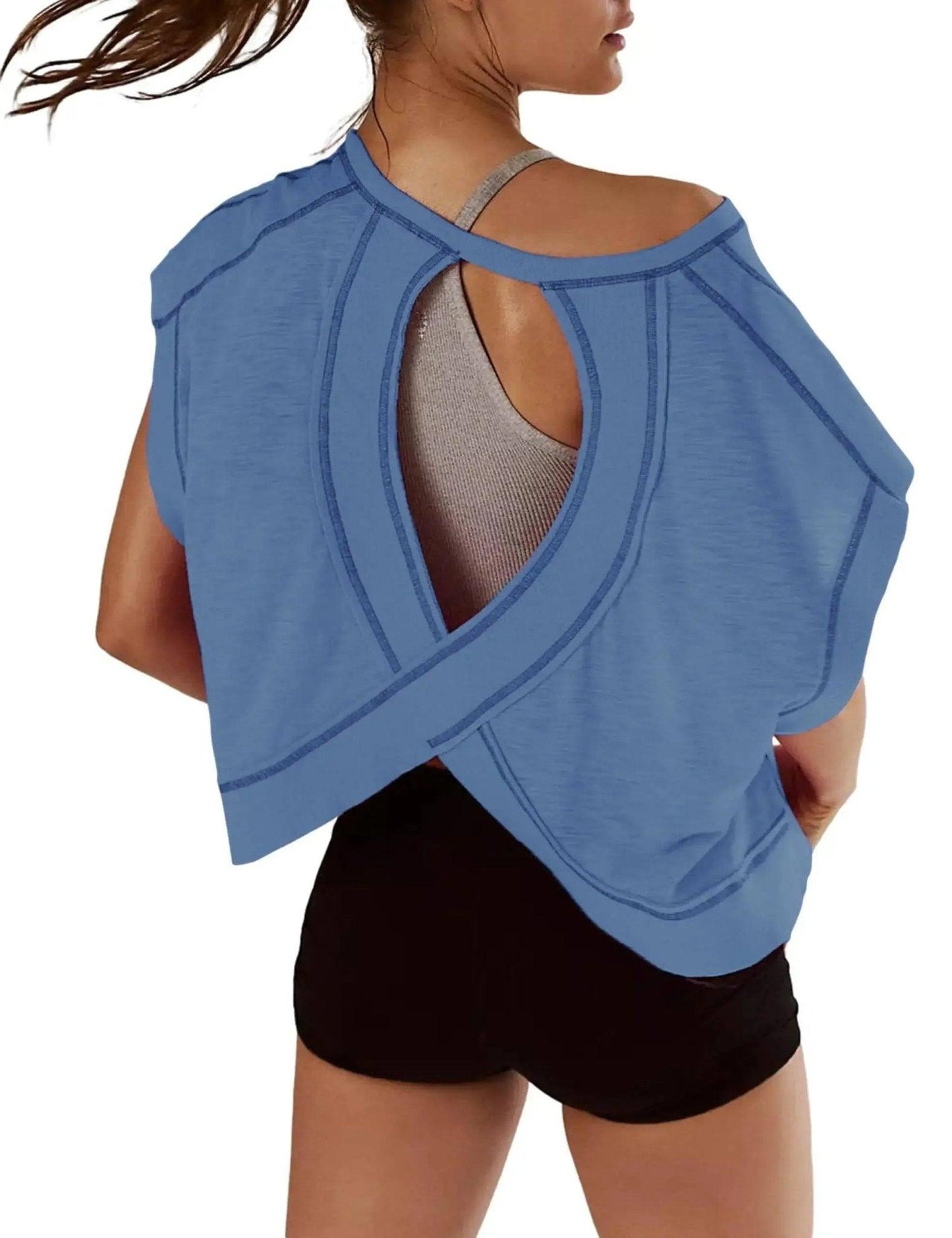Blue women's workout top with open back design, paired with black shorts for gym or yoga