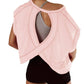 Pink open-back workout top with crisscross design, paired with black shorts for women's active fashion