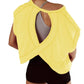 Yellow open-back workout top with crisscross design, paired with black shorts for women's fitness fashion