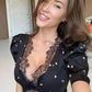 Woman in black lace top with floral print, stylish fashion outfit