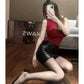 Woman in red sleeveless top and black leather mini skirt, posing with phone, fashion outfit