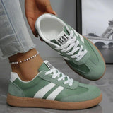 Green and white women's sneakers with 'Stay Real' text, casual fashion footwear