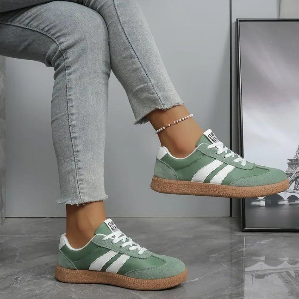 Green women's sneakers with white stripes, casual fashion footwear for everyday wear