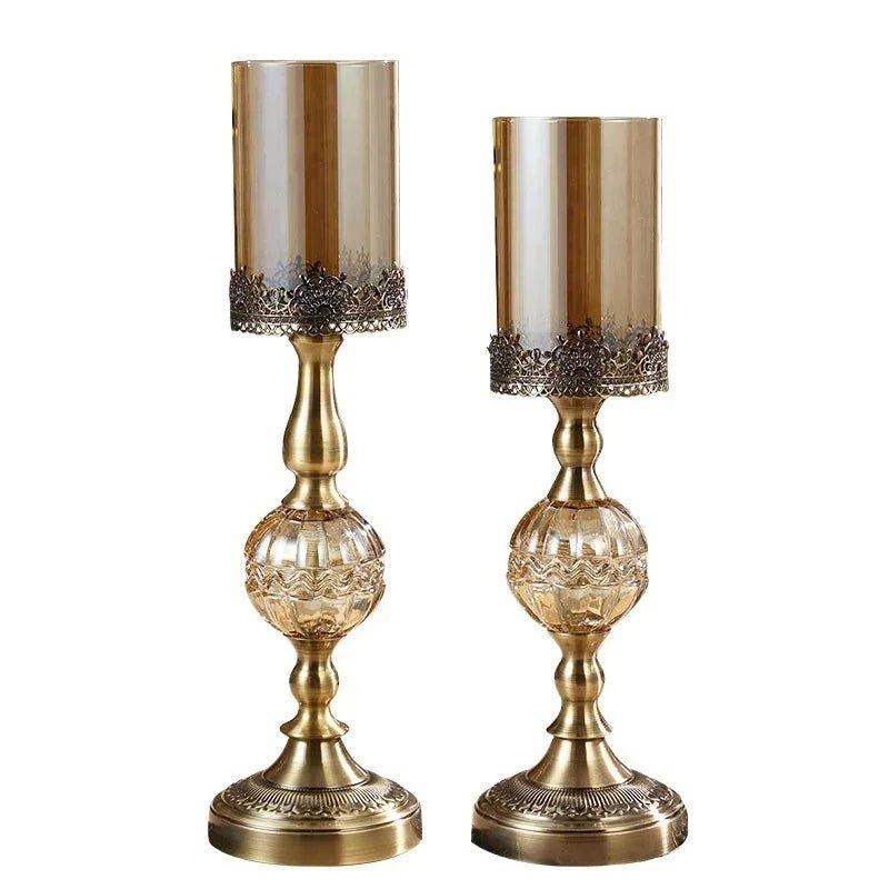 Elegant gold candle holders with ornate metal bases and glass shades for home decor