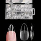 Clear stiletto false nails in organized case, perfect for women's fashion and beauty looks