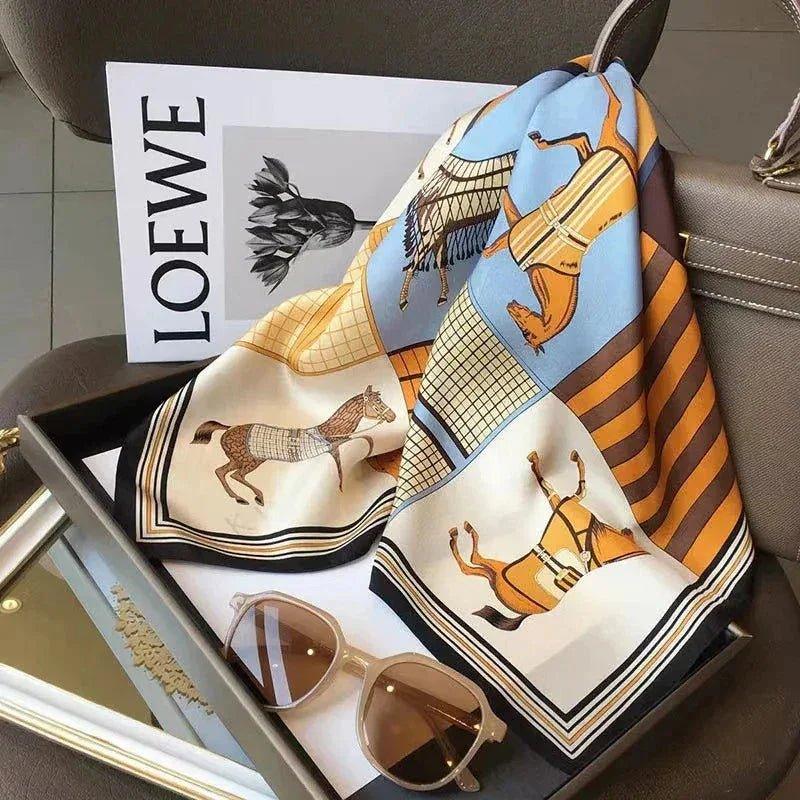 Elegant horse-print silk scarf with sunglasses and LOEWE magazine, perfect for women's fashion accessories.