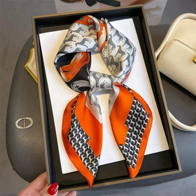 Stylish orange and black patterned silk scarf in gift box, perfect for women's fashion accessories