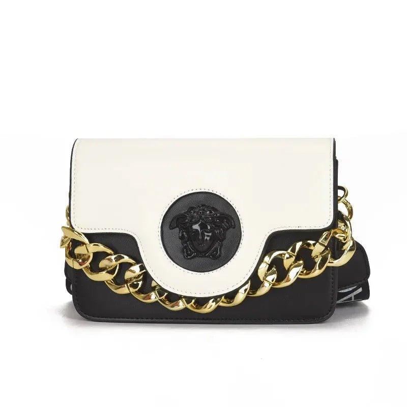 White and black fashion handbag with gold chain strap and Medusa emblem, luxury women's accessory