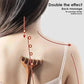Wooden back massager with six prongs for deep tissue relief, shown on woman’s shoulders
