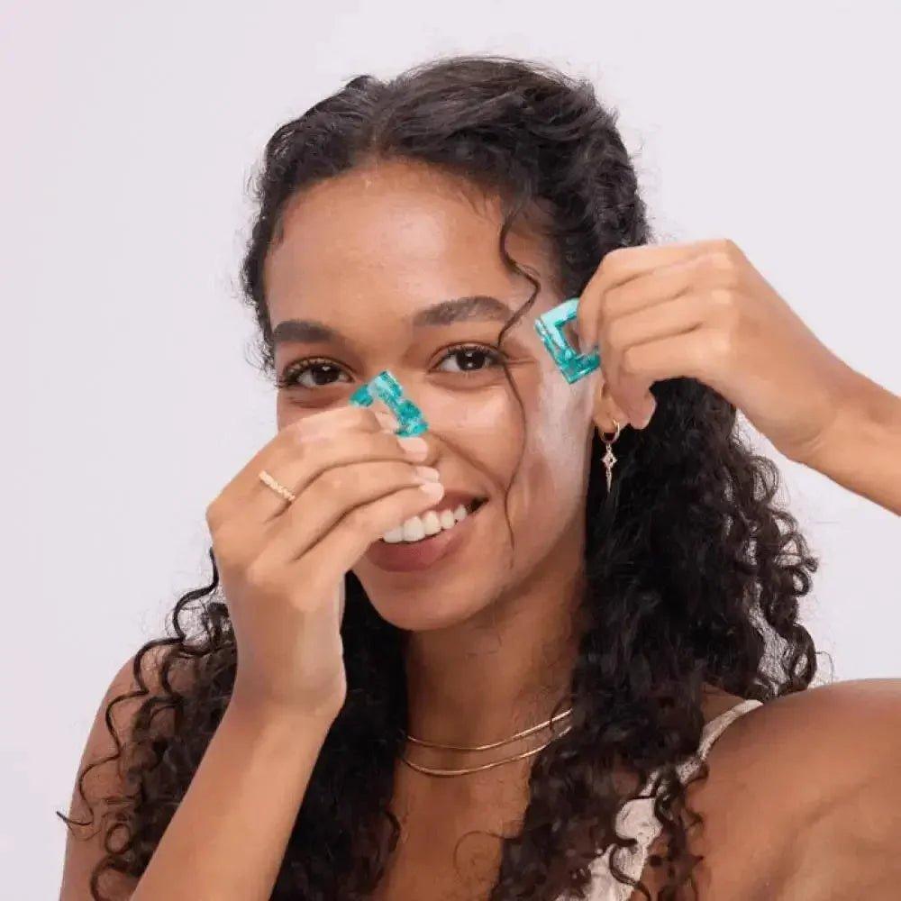Woman styling curly hair with turquoise hair clips, fashion accessories for everyday beauty