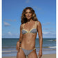 Woman in striped bikini on beach, summer fashion swimwear