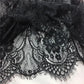 Black floral lace fabric with intricate embroidery, perfect for women's fashion and elegant dresses.