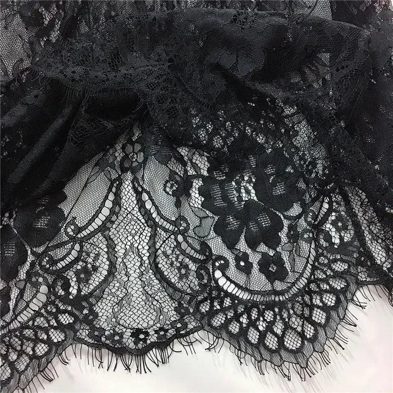 Black floral lace fabric with intricate embroidery, perfect for women's fashion and elegant dresses.