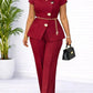 Burgundy women's peplum suit with gold buttons, wide-leg pants, and black handbag for elegant fashion