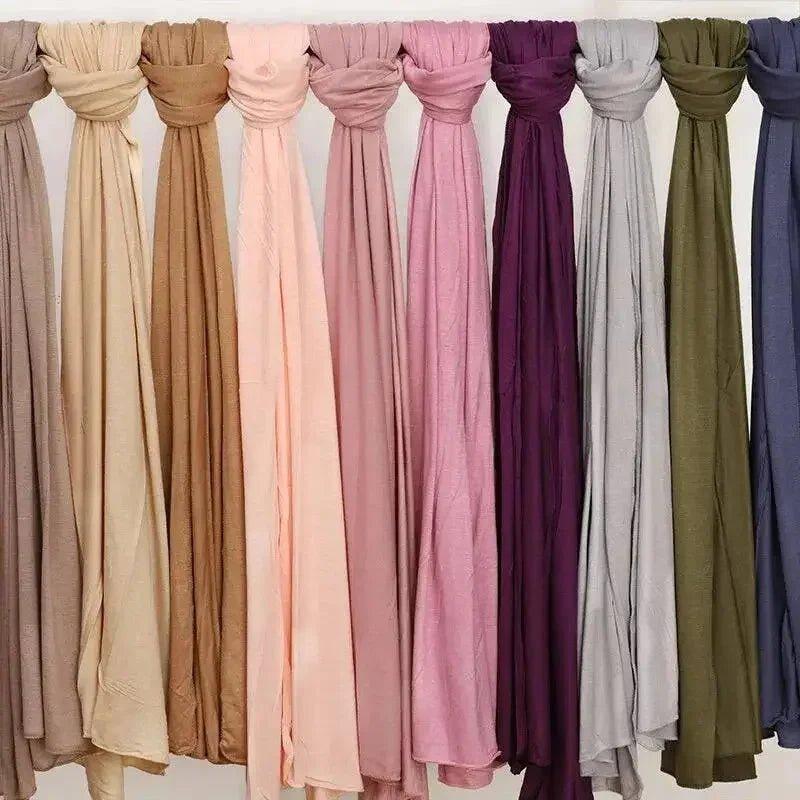 Assorted women's fashion scarves in soft pastel and bold colors for stylish outfits