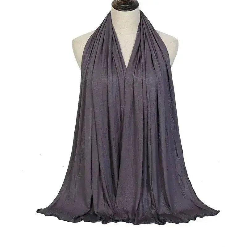 Elegant gray scarf draped on mannequin, stylish women's fashion accessory