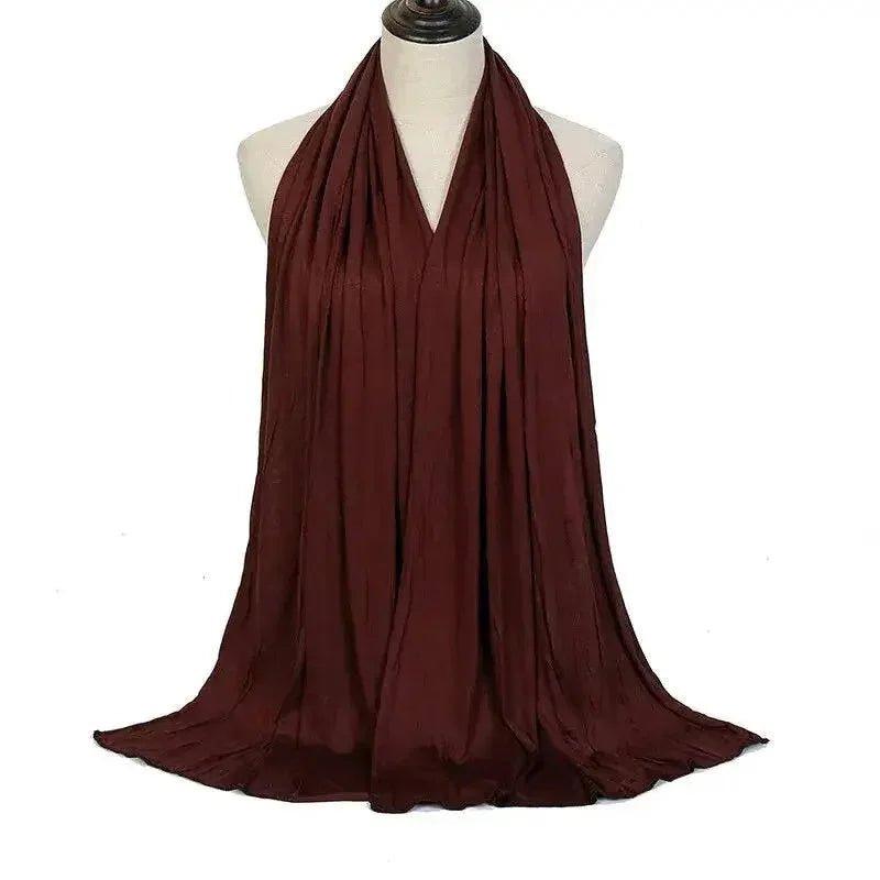 Elegant burgundy scarf draped on mannequin, perfect for women's fashion and beauty