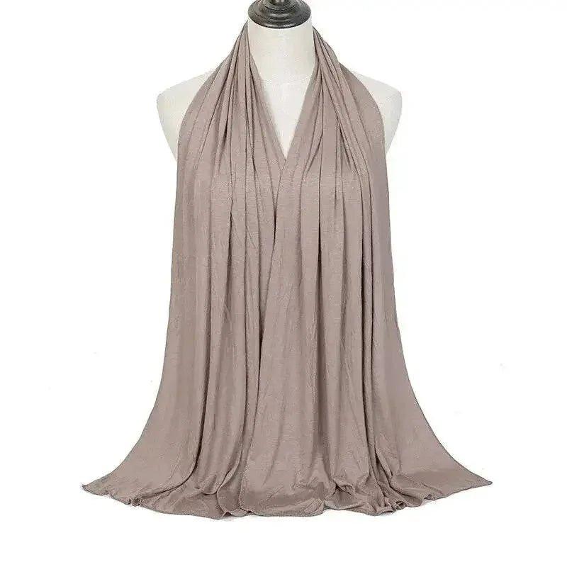 Elegant beige scarf draped on mannequin, perfect for women's fashion and beauty looks