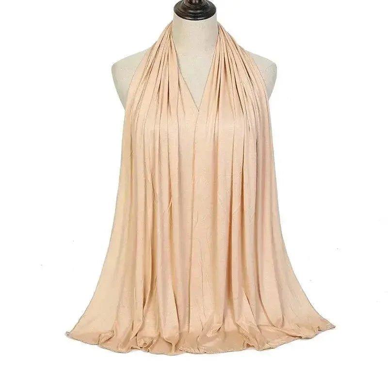 Elegant beige halter neck dress with flowing pleats, perfect for women's fashion