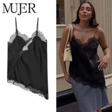 Black lace-trimmed satin camisole for women's fashion, styled with denim skirt and beige bag